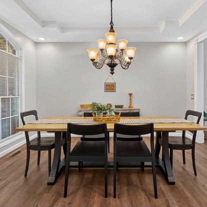 Warmly staged living room with beige sofa, terracotta and cream throw pillows, light oak coffee table, and cognac leather chair